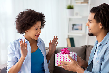 Image showing happy couple with gift box at home