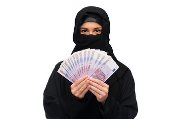 Image showing muslim woman in hijab with money over white