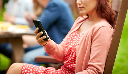 Image showing woman with smartphone and friends at summer party