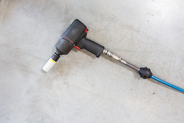 Image showing screwdriver on floor at tire shop