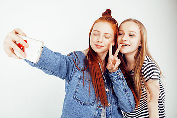 Image showing lifestyle people concept: two pretty stylish modern hipster teen girl having fun together, happy smiling making selfie 