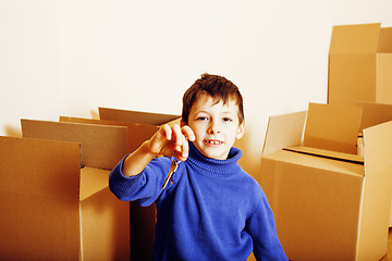 Image showing little cute boy in empty room, remoove to new house. home alone, lifestyle people concept