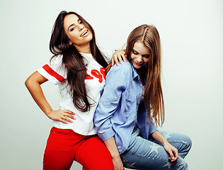 Image showing best friends teenage girls together having fun, posing emotional on white background, besties happy smiling, lifestyle people concept, blond and brunette multi nations 