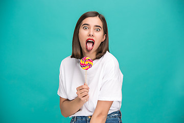 Image showing The young woman with colorful lollipop