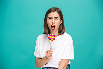 Image showing The young woman with colorful lollipop