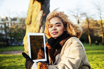 Image showing young cute blond african american girl student holding tablet an