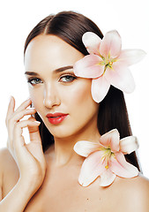 Image showing young attractive lady close up with hands on face isolated flowe