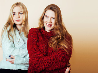 Image showing Two young girlfriends in winter sweaters indoors having fun. Lif