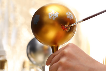 Image showing Decorating baubles, handmade Painting of Christmas decorations