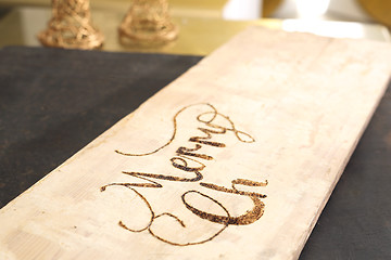 Image showing Merry christmas, burning subtitles in wood