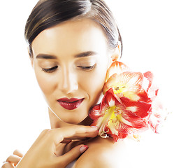 Image showing young pretty brunette woman with red flower amaryllis close up i