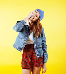 Image showing young pretty red hair teenage hipster girl posing in glasses emotional happy smiling on yellow background, lifestyle people concept