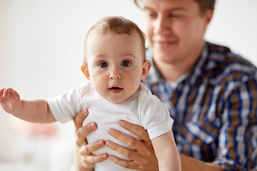 Image showing happy young father with little baby at home