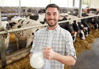 Image showing man or farmer with cows milk on dairy farm