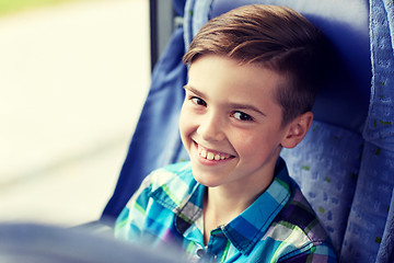 Image showing happy boy sitting in travel bus or train