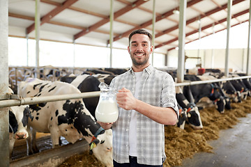 Image showing man or farmer with cows milk on dairy farm