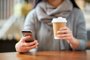 Image showing close up of woman with smartphone and coffee