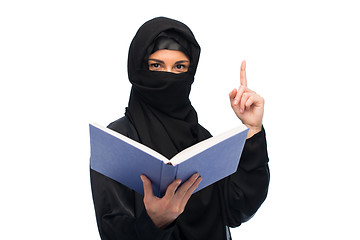 Image showing muslim woman in hijab with book over white