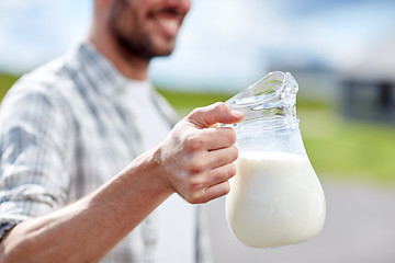 Image showing man or farmer with jug of milk at countryside