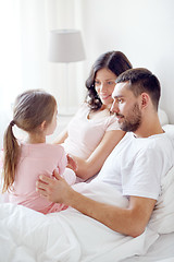 Image showing happy family in bed at home