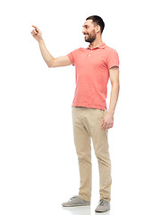 Image showing happy man touching something imaginary