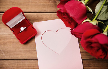 Image showing close up of diamond ring, roses and greeting card