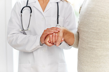 Image showing close up of doctor holding old man hand