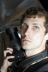 Image showing The young man – photographer with digital camera