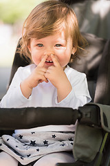 Image showing baby girl sitting in the pram