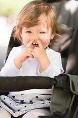 Image showing baby girl sitting in the pram