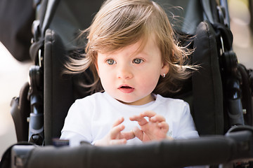 Image showing baby girl sitting in the pram