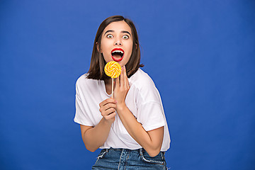 Image showing The young woman with colorful lollipop