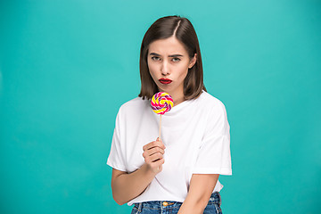 Image showing The young woman with colorful lollipop