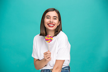 Image showing The young woman with colorful lollipop