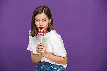 Image showing The young woman with colorful lollipop