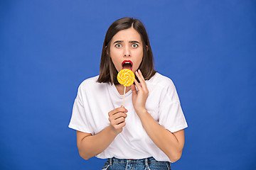 Image showing The young woman with colorful lollipop