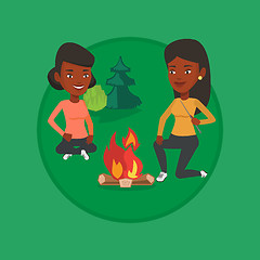 Image showing Two friends sitting around bonfire in camping.