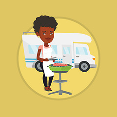 Image showing Woman having barbecue in front of camper van.