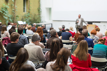 Image showing Man giving presentation in lecture hall at university.