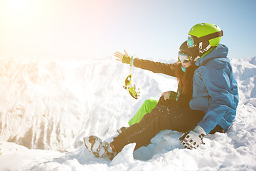 Image showing Girl , guy among winter mountain