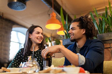Image showing happy couple with drinks at cafe or bar