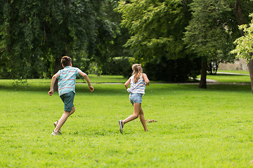 Image showing group of happy kids or friends playing outdoors