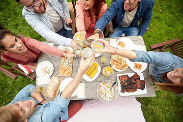 Image showing happy friends with drinks at summer garden party