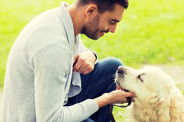 Image showing close up of man with labrador dog outdoors