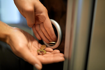 Image showing hands with euro coins at vending machine