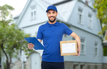 Image showing happy delivery man with parcel box and clipboard