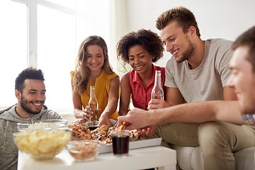 Image showing happy friends with drinks eating pizza at home