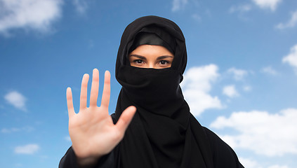 Image showing muslim woman in hijab showing stop sign