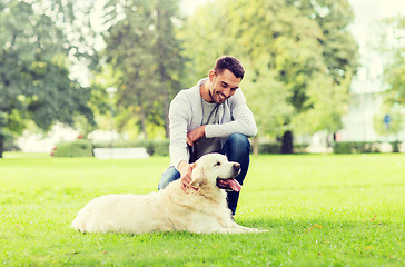 Image showing happy man with labrador dog walking in city