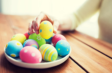 Image showing close up of woman hands with colored easter eggs